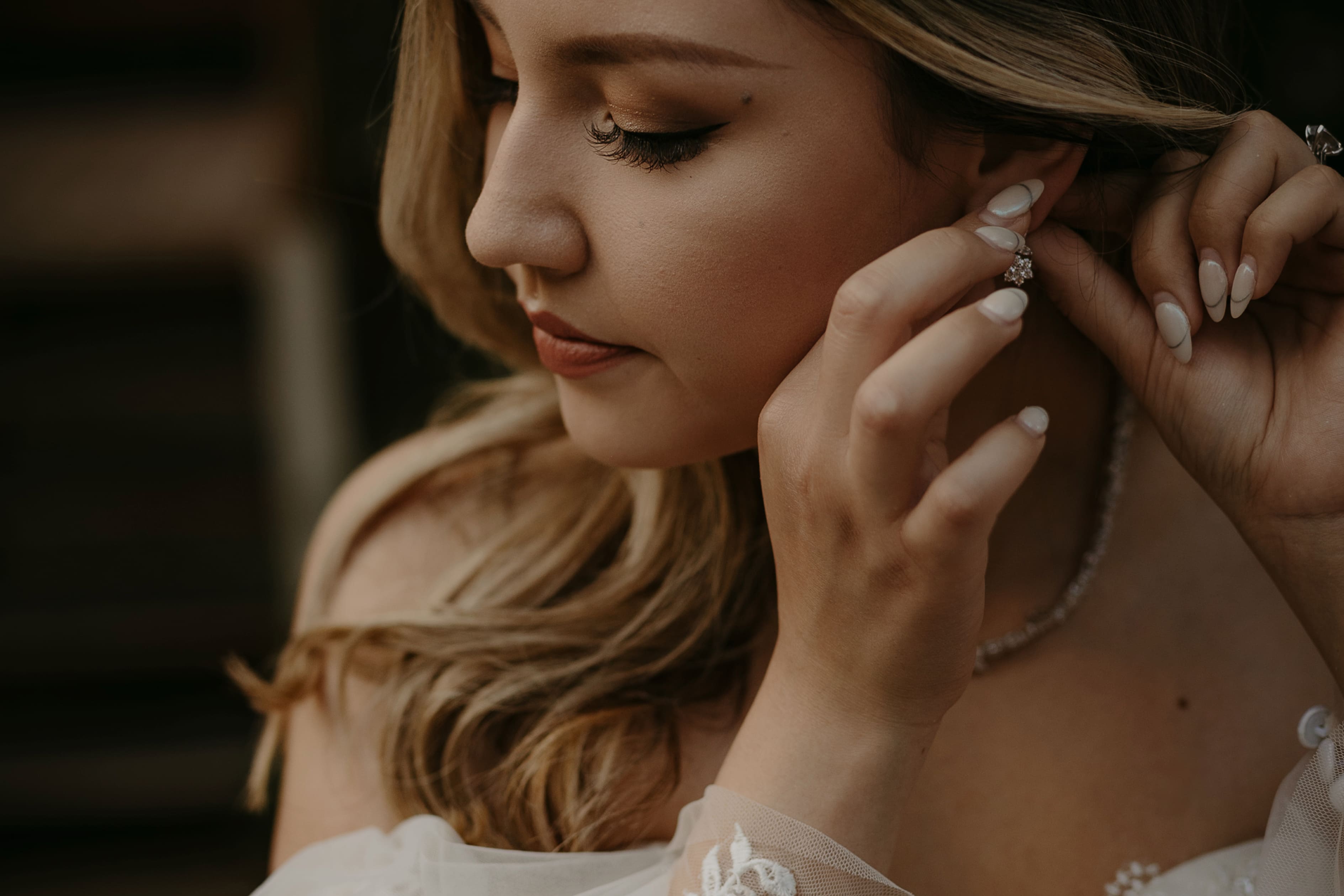 Bride protrait, looking down at her painted finger nails.